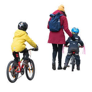 woman with two kinds on the bikes walking in the street