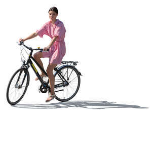 backlit woman in summer riding a bike