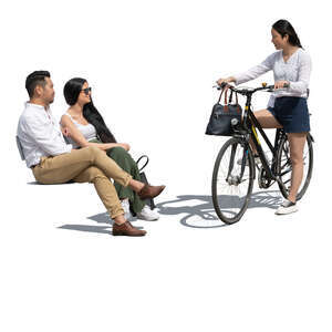 woman with a bike talking to two friends sitting on a bench