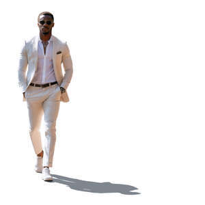 backlit black man in a white suit walking