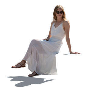 backlit woman in a white summer dress sitting