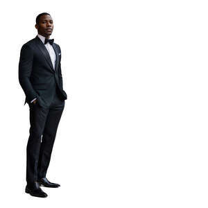 young black man in a black suit with a bow tie standing