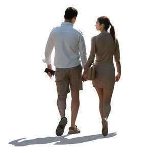 backlit couple walking hand in hand