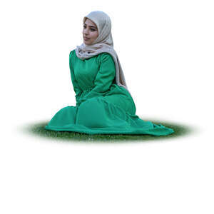 muslim woman with a hijab sitting on the grass