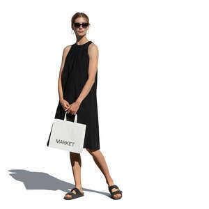 woman in a black dress with a shopping bag standing