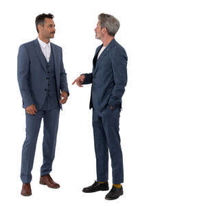 two men in suits standing and talking