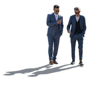 backlit men wearing suits walking