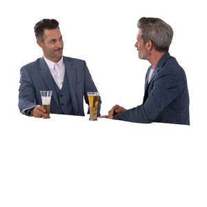 two cut out businessmen standing at the bar counter and drinking beer