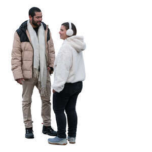 man and woman with with earmuffs standing and talking