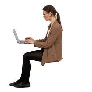 side view of a woman sitting and working with computer