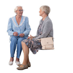two cut out elderly ladies sitting and talking