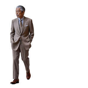 older japanese gentleman in a suit walking