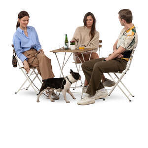 group of three friends and a dog sitting in a coffeeshop