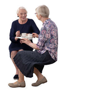 two cut out elderly women sitting in a cafe and drinking coffee