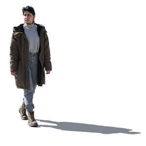 cut out backlit latino woman wearing a parka walking 