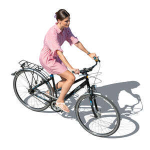 cut out woman in a summer dress riding a bike seen from above