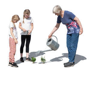 grandmother and grandkids planting in the garden