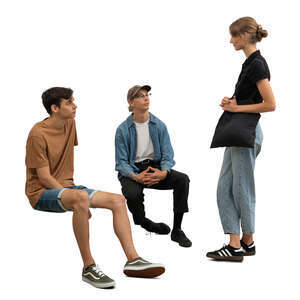 woman standing and talking to two men sitting