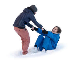 one woman helping another to get up from sitting in snow