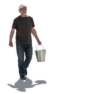 cut out backlit older man carrying a bucket