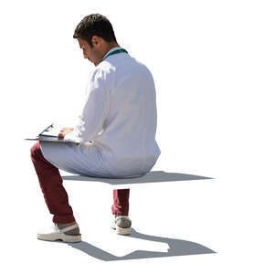 cut out backlit doctor sitting and writing notes