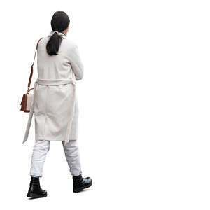 woman wearing a white overcoat walking