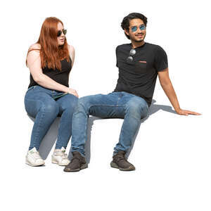 two cut out people sitting outside