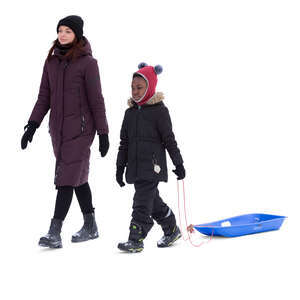 woman and a kid with a sledge walking