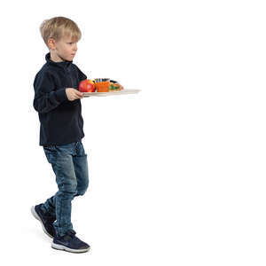 little boy walking with his lunch tray