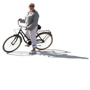 backlit older woman with a bike