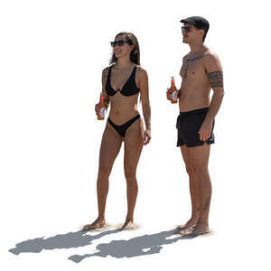 backlit man and woman holding refreshing drinks standing on the beach