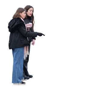 two women standing and picking smth from the counter