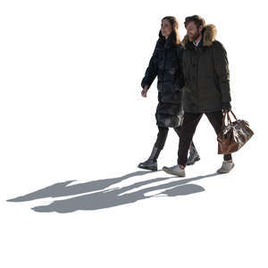 backlit man and woman walking on a sunny winter day