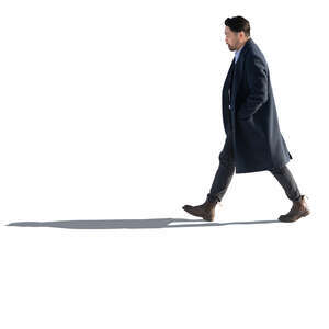 backlit japanese man wearing an overcoat walking