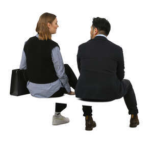 two people sitting and talking in an office environment