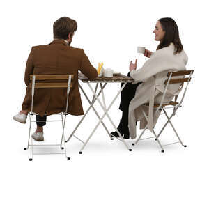 back view of a man and woman sitting in a cafe