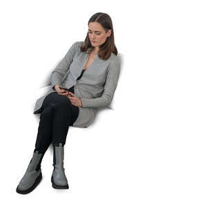 cut out woman sitting on a sofa and texting