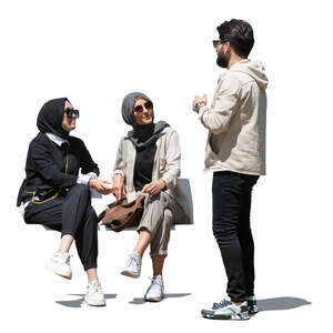 man talking to two young muslim women