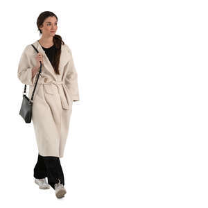 cut out woman in a white overcoat walking