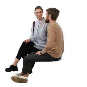 man and woman sitting and talking