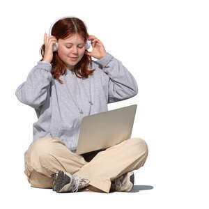 teenage girl sitting with computer and listening to music