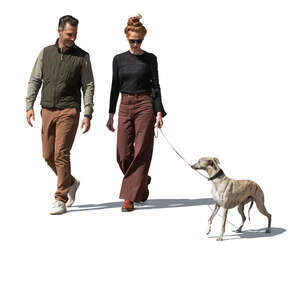 man and woman walking a dog