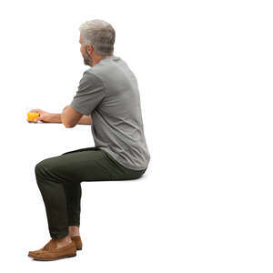 man sitting and drinking orange juice