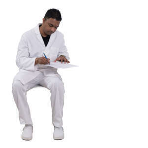 indian doctor sitting and writing