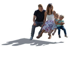 cut out backlit man and woman and two small children sitting