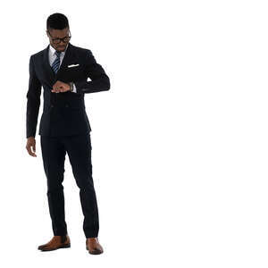 cut out chic black man wearing a suit standing and checking his wrist watch