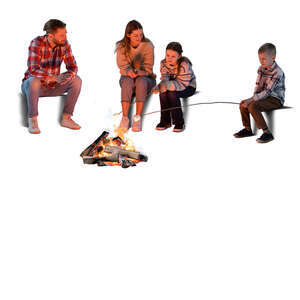 family sitting around a fire and cooking marshmallows