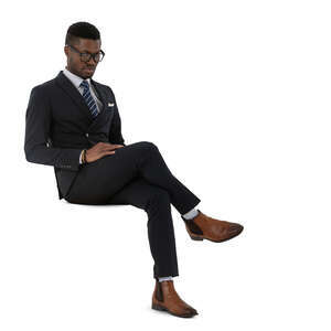 cut out black man in a dark suit sitting