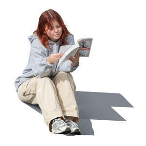 teenage girl sitting and reading a book