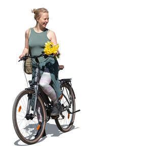 woman holding flowers and riding a bike